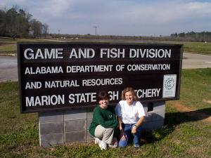 Judson students beside the Marion State Hatchery Sign