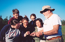 Dan James showing students a small rattlesnake